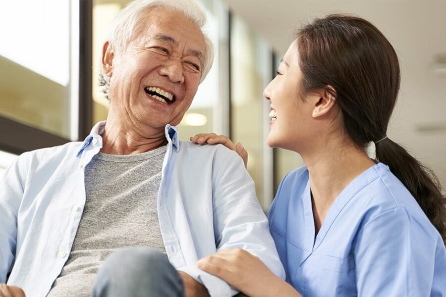 nurse taking care of asian elderly man on a wheelchain